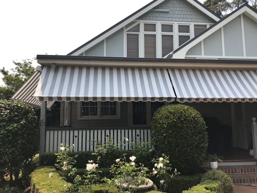 Folding arm awning extended over a garden
