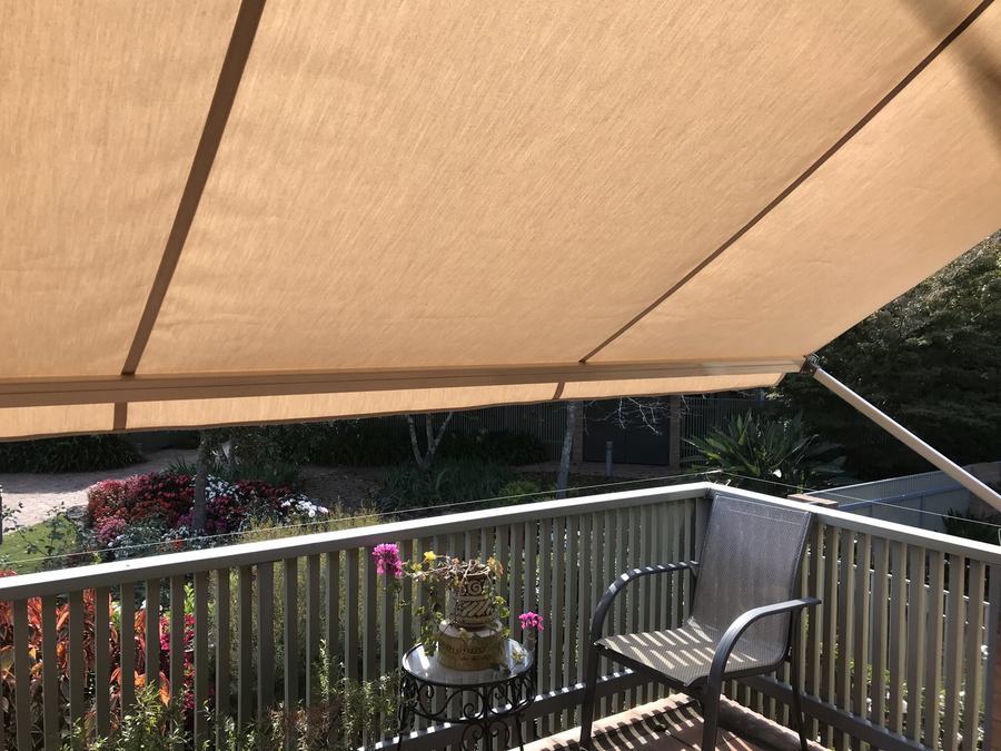 Tan striped awning fabric close up over a deck