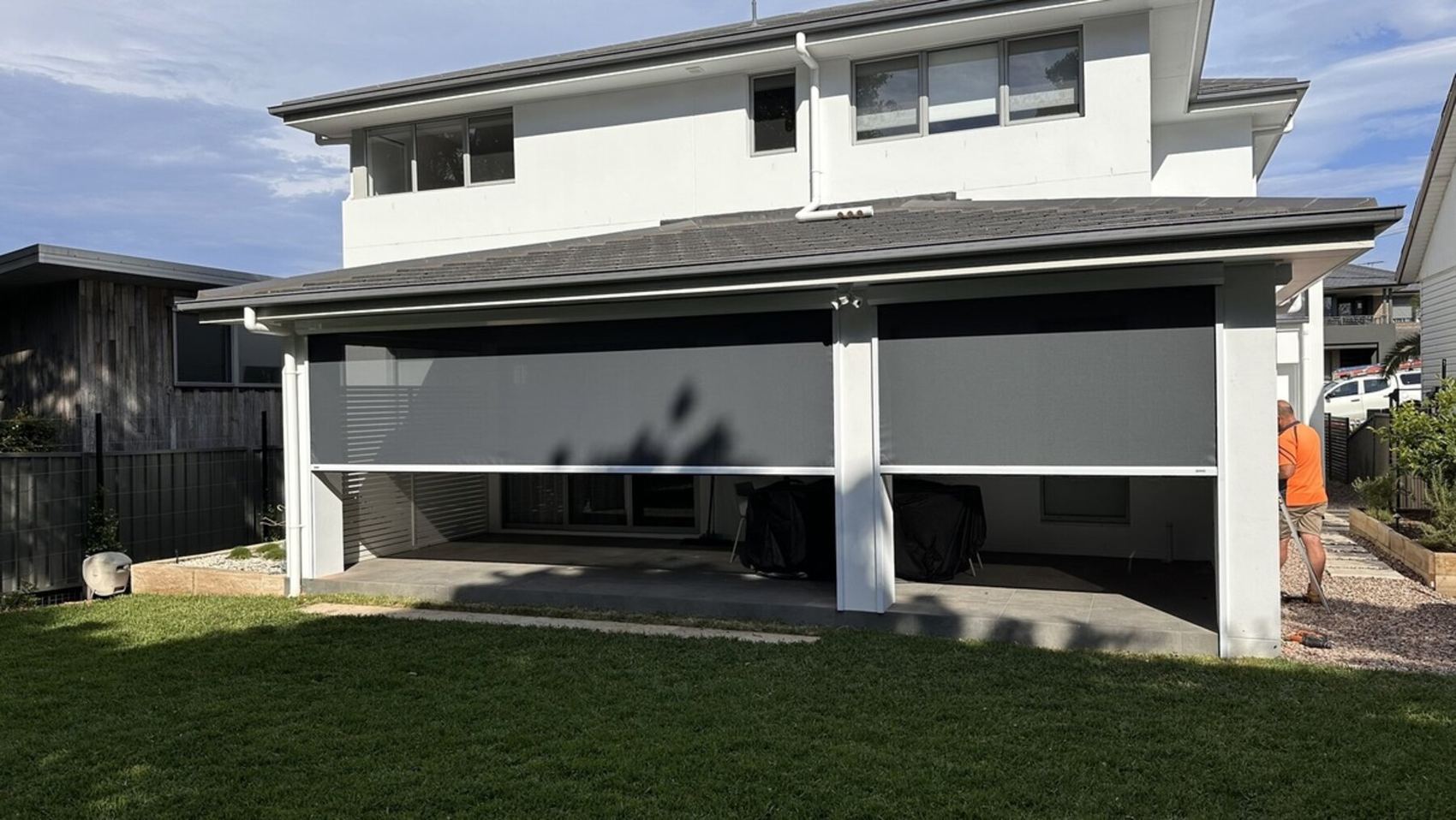 Straight drop blinds closing in the front of a carport