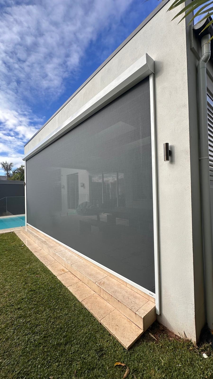 Side view of a zip tracked outdoor blind in its track