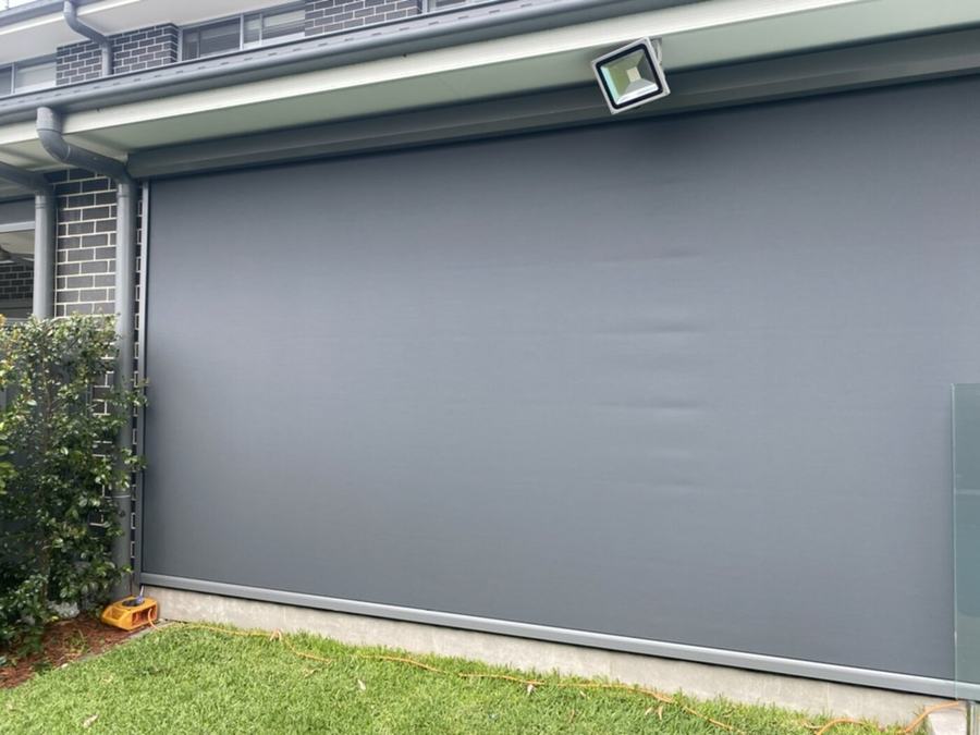 Zip tracked blind fully closed across a garage opening